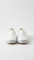 Minimalist white slip-on sneakers